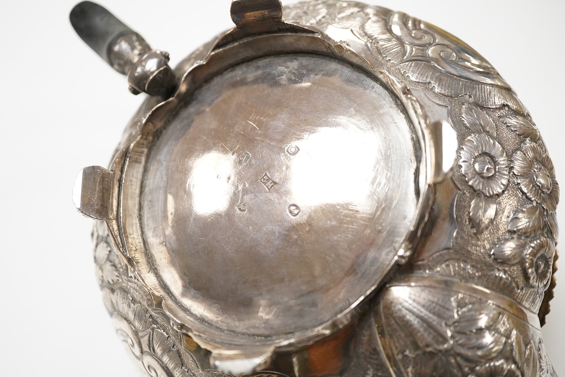 A late George III silver circular teapot, by Samuel Hennell, London, 1818, with later embossed decoration, gross weight 26.9oz.